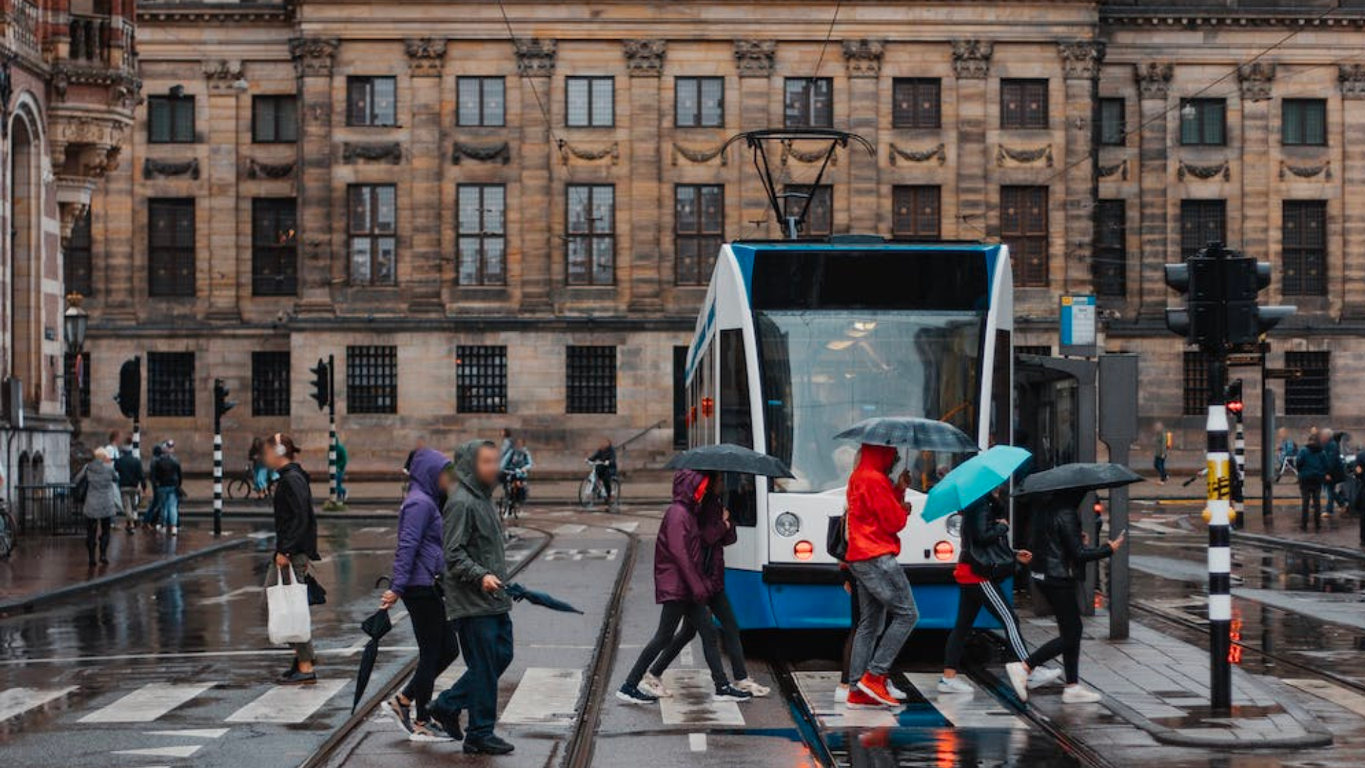 Image of pedestrians crossing in front of a tram