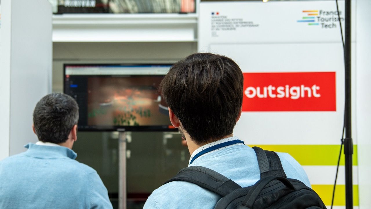 Two people watching LiDAR software demonstration from Outsight